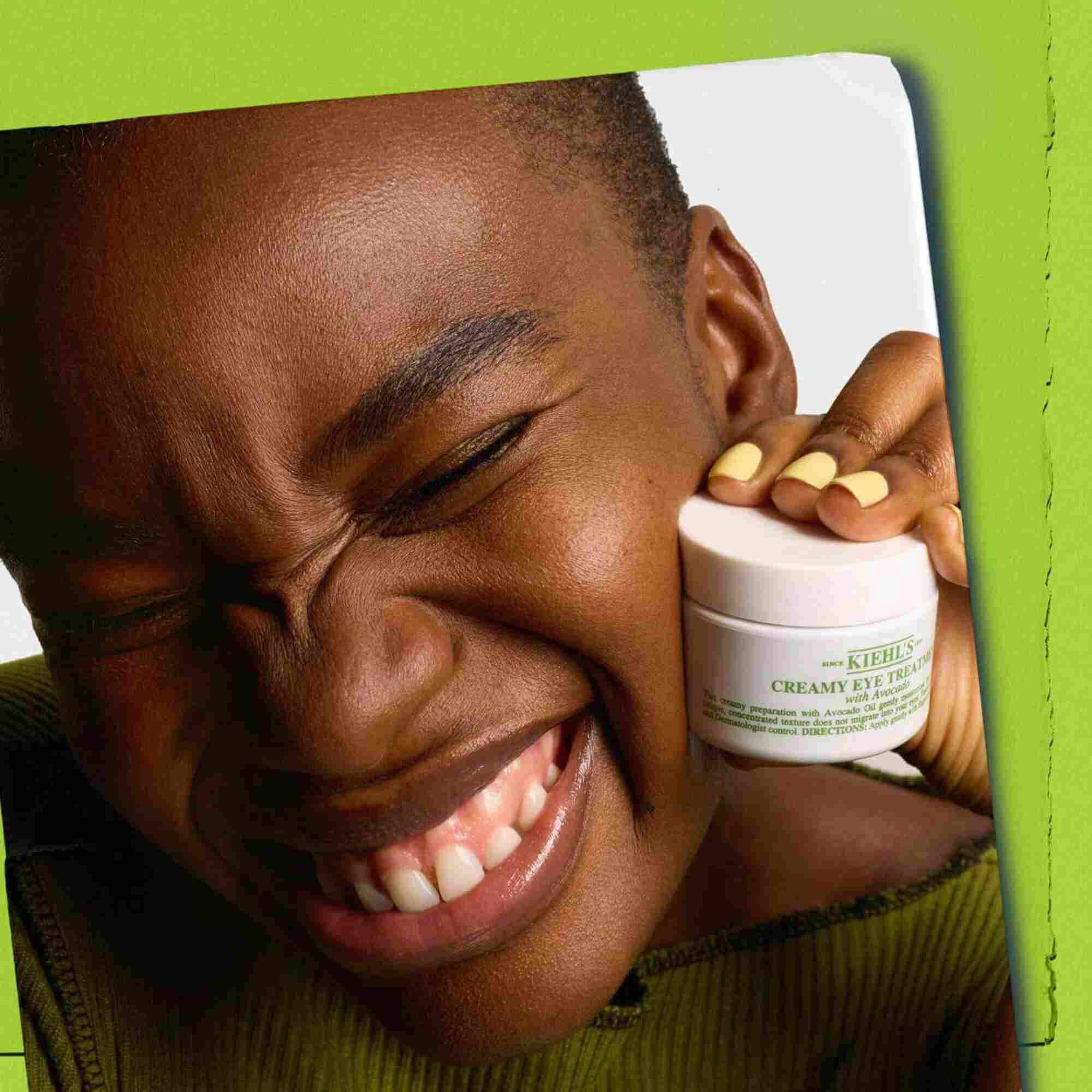 Model holding jar of Kiehl's Creamy Eye Treatment with Avocado