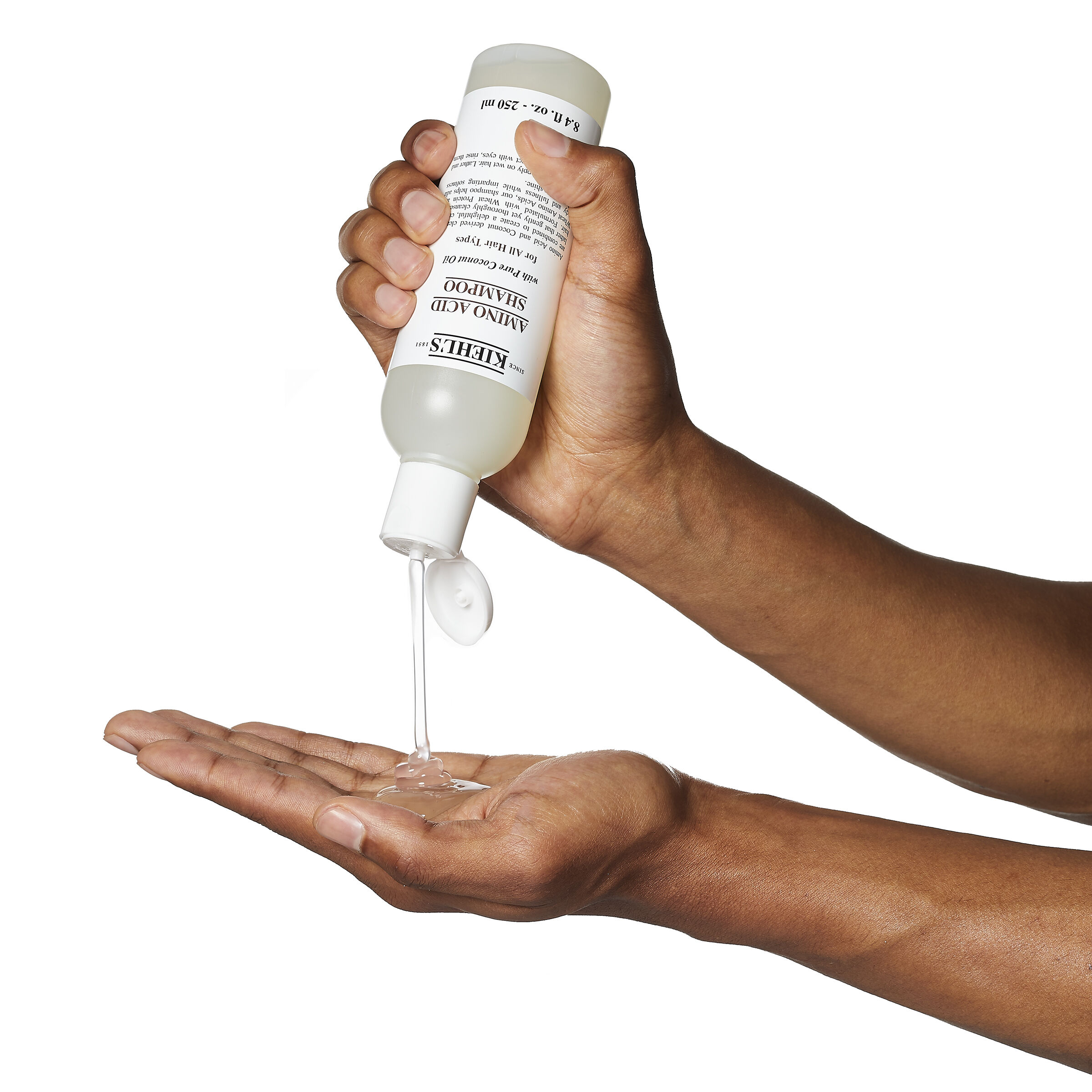 Model with bubbles on their head from Kiehl's Amino Acid Shampoo