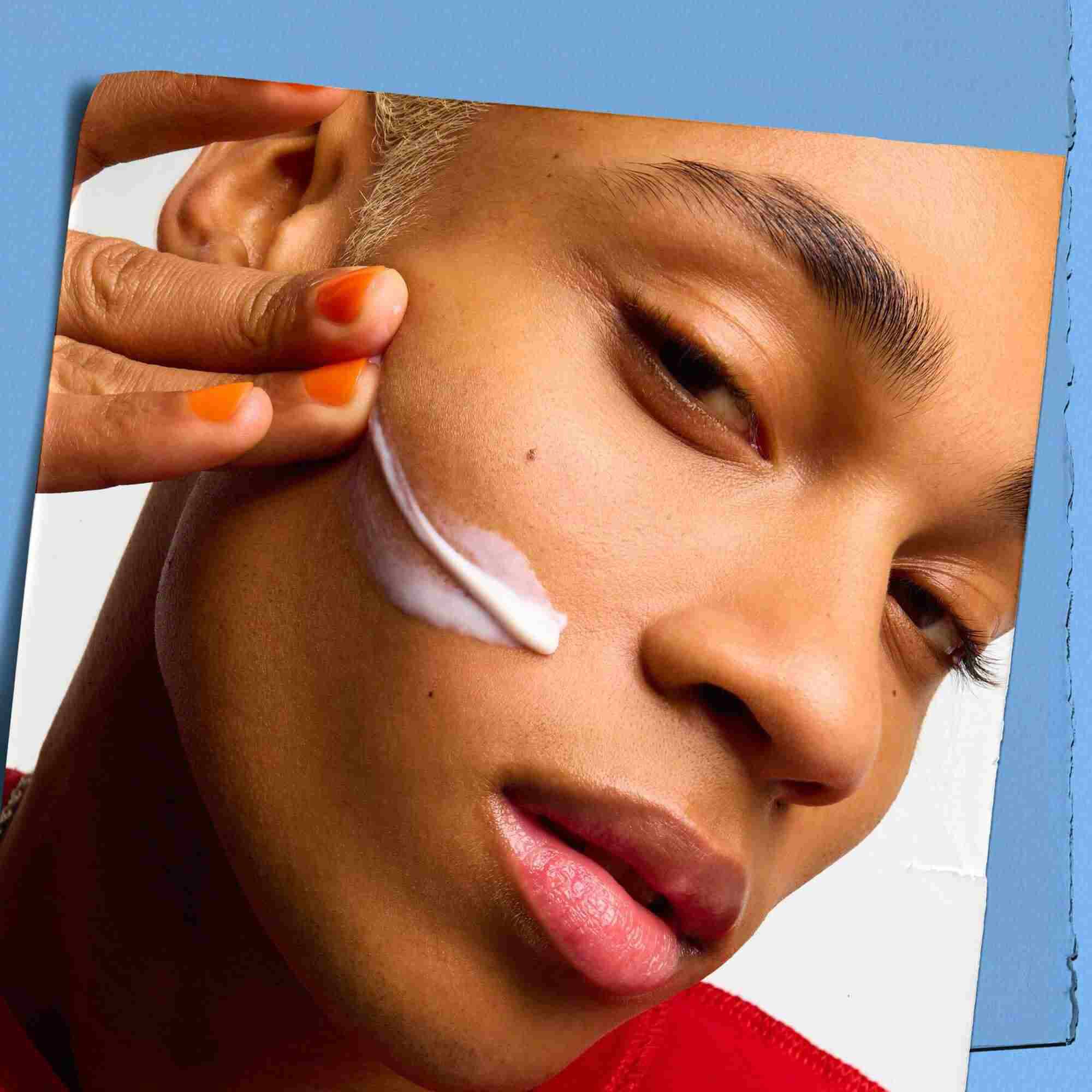Model with a texture sample of Kiehl's Ultra Facial Moisturizer on their face