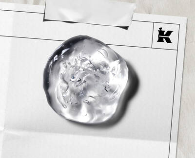 Close-up of a clear, textured skincare gel droplet on a laboratory document, featuring Kiehl’s iconic "K" logo, illustrating the brand's clinical approach to formula development. ​